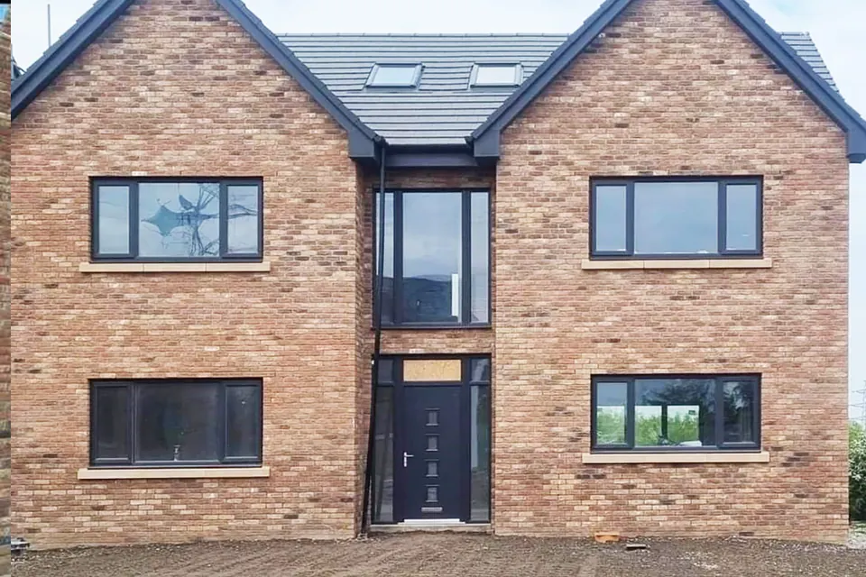 Double glazing in Workington: new build house fitted with anthracite grey triple glazed windows and a composite door by Cumbria Superglaze
